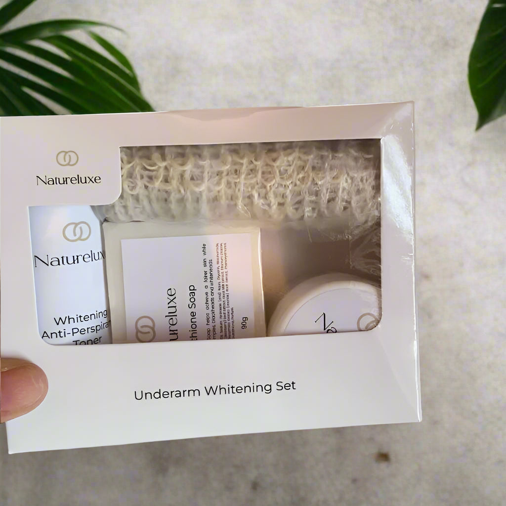Natureluxe underarm whitening set packaging on a textured surface with green leaves in the background. multiple products in 12set
